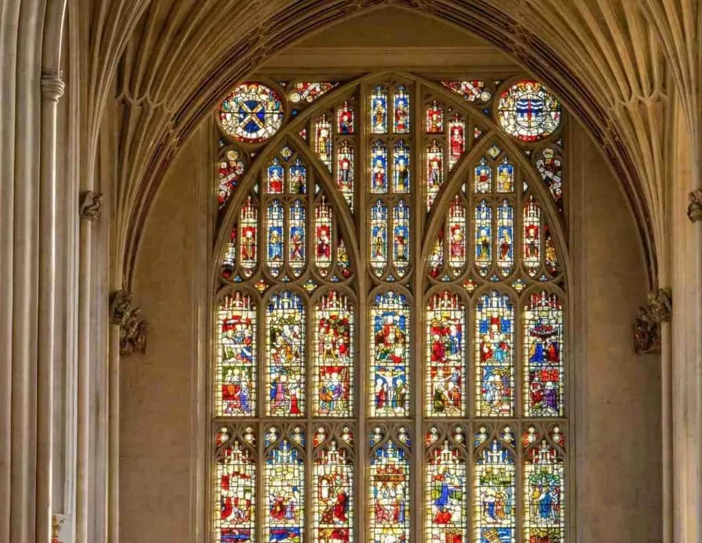 Stained-glass east window and fan-vaulted ceiling inside Bath Abbey