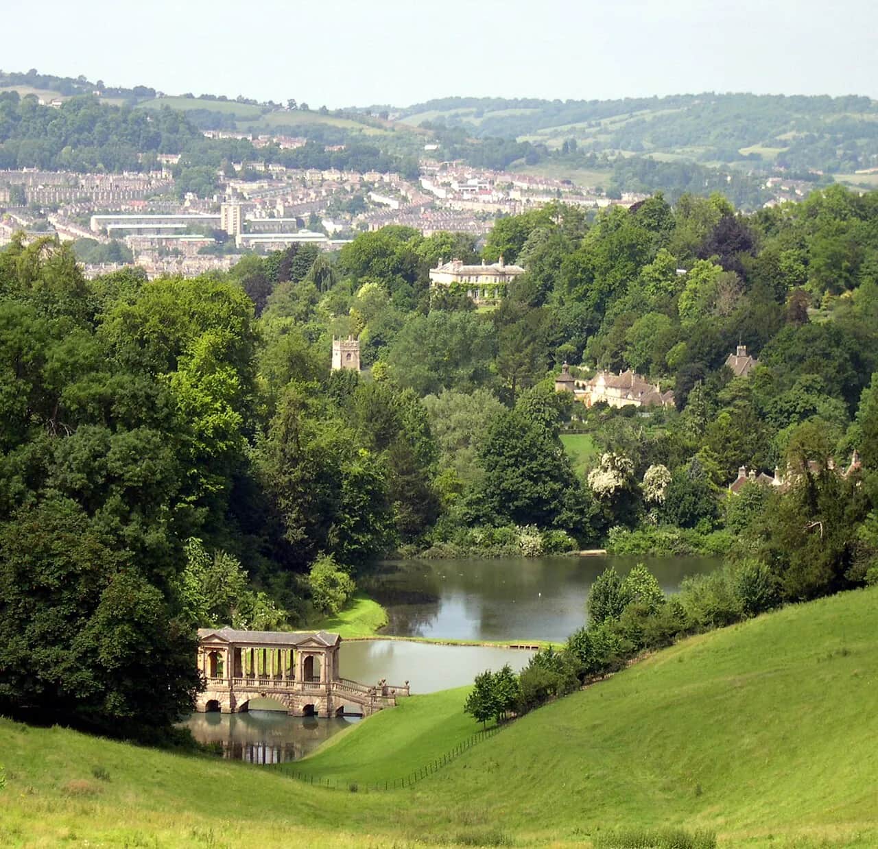 The Palladian bridge at Prior Park Landscape Garden, reflected in the lake with Bath stone arches