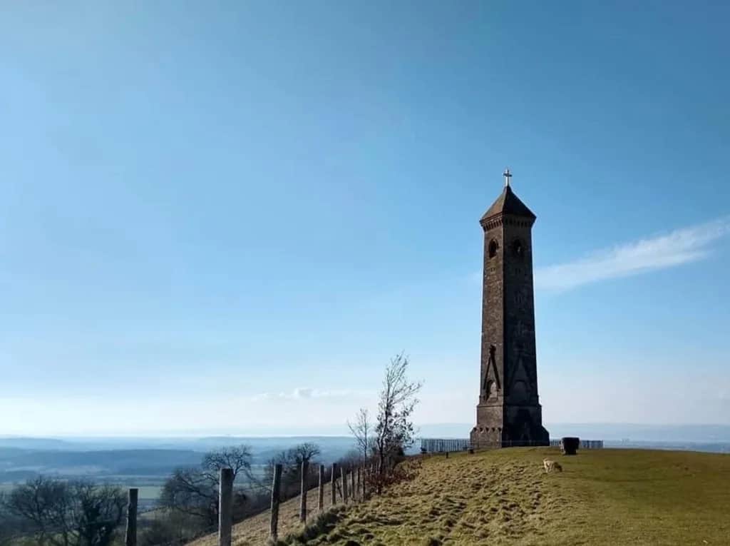 Tyndale Monument, a tall stone tower on a grassy hilltop with wide views across the Severn Vale