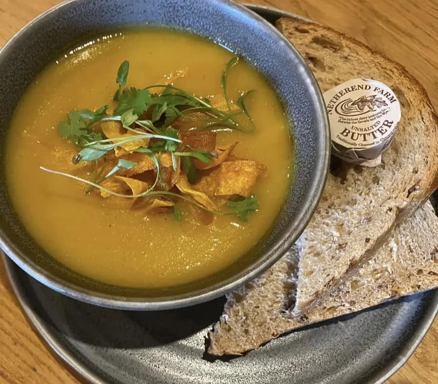 Bowl of soup with seeded bread and Netherend Farm butter at The Old Spot