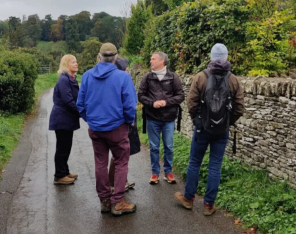 Group of walkers on a guided tour along a country lane