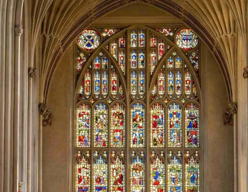 Stained-glass east window and fan-vaulted ceiling inside Bath Abbey