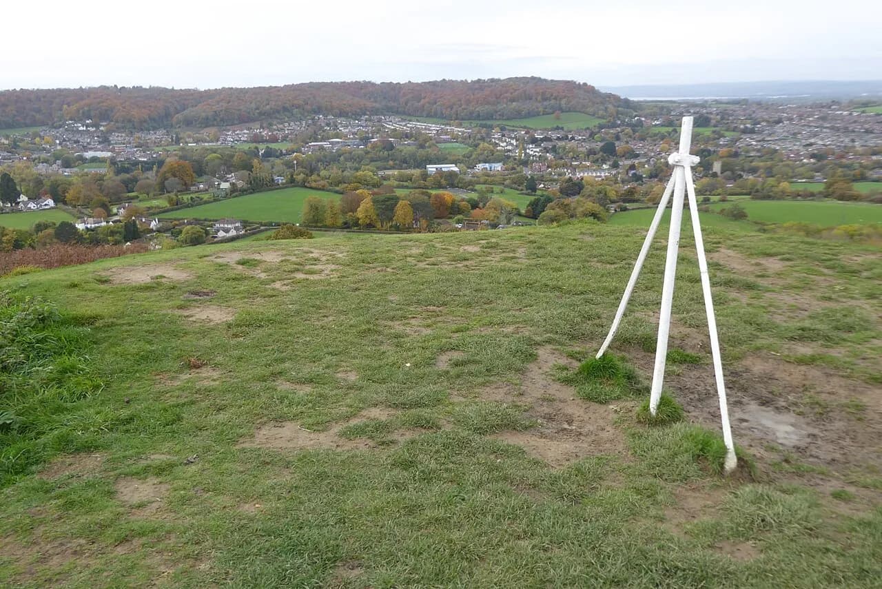 View from Cam Peak over Dursley in the valley, with rolling fields and a wooded autumn ridge beyond