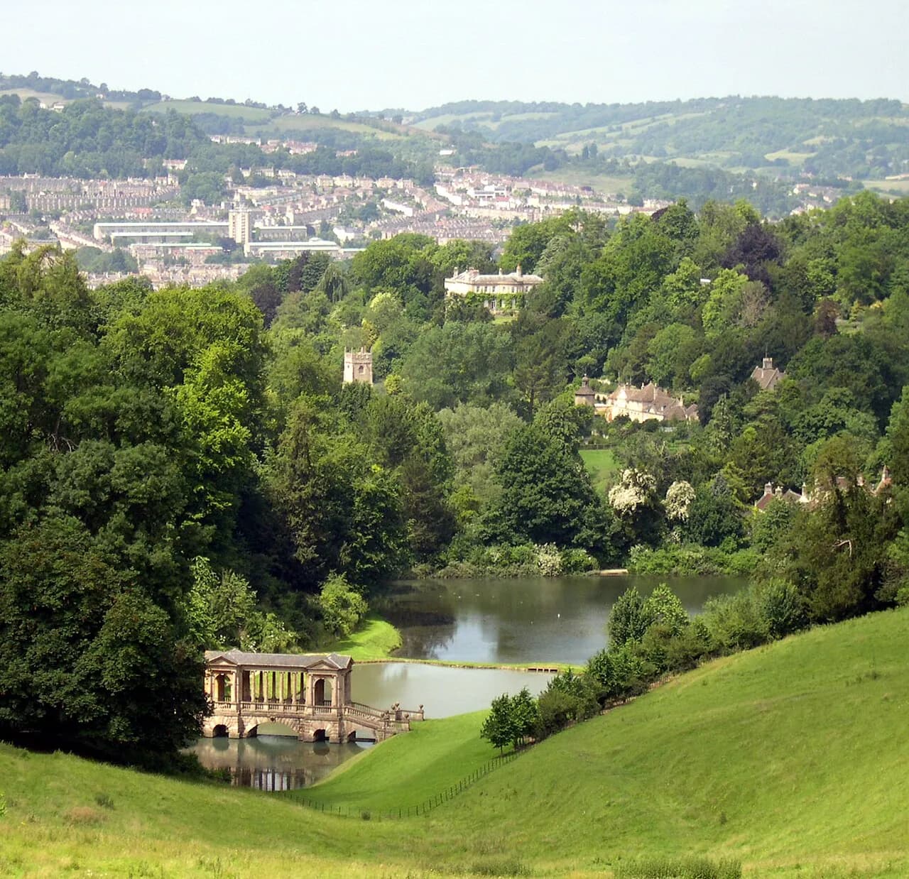 The Palladian bridge at Prior Park Landscape Garden, reflected in the lake with Bath stone arches