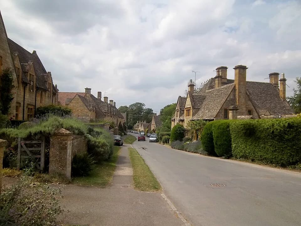 Cotswold-stone cottages and walls along the High Street in Stanton, Gloucestershire