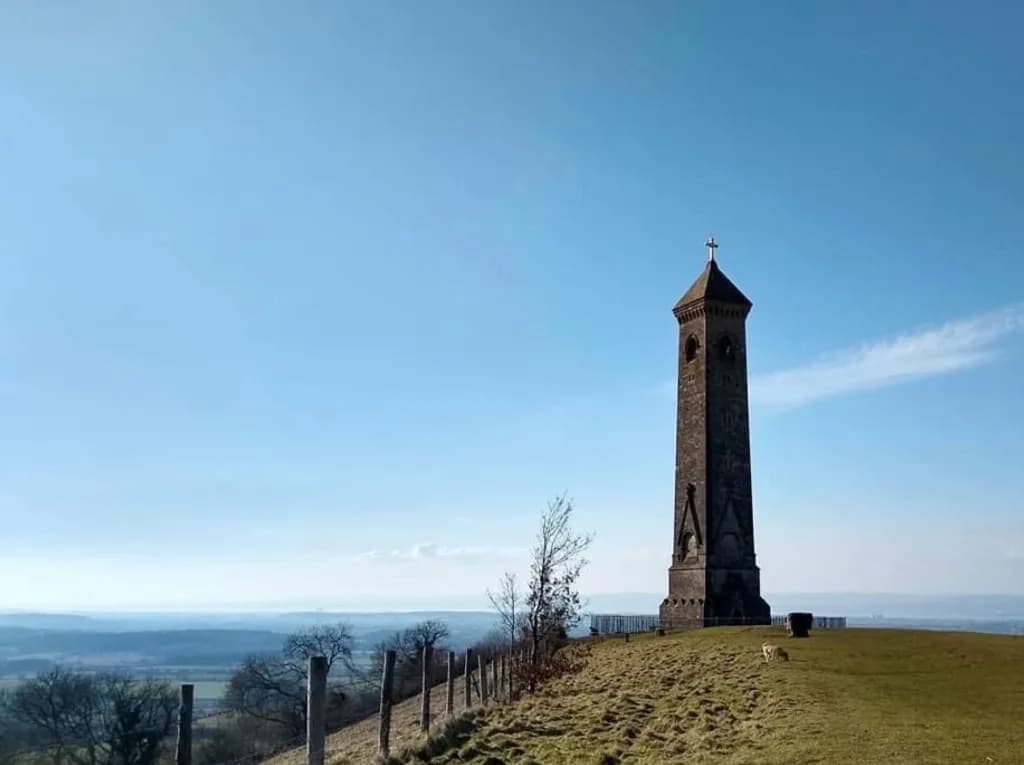 Tyndale Monument, a tall stone tower on a grassy hilltop with wide views across the Severn Vale