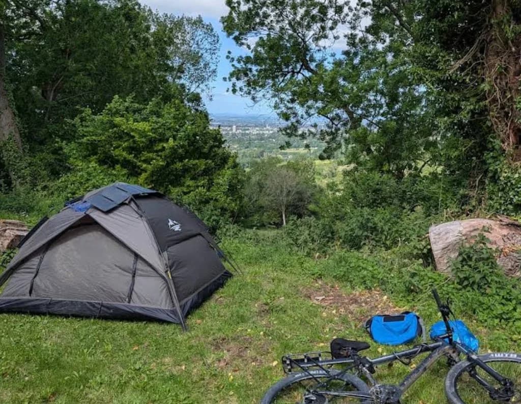 Tent and bike overlooking Cheltenham and the valley from Colgate Farm