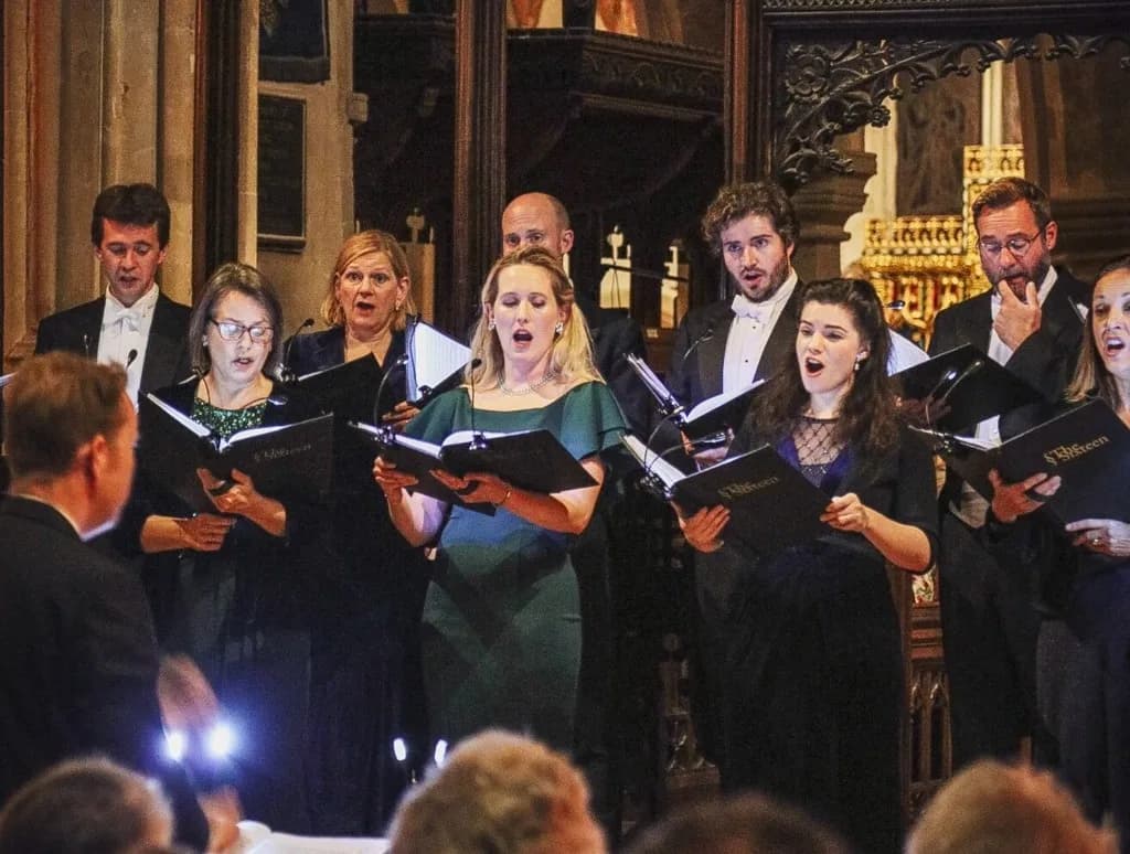 Choir performing in a historic Cotswold church during a concert